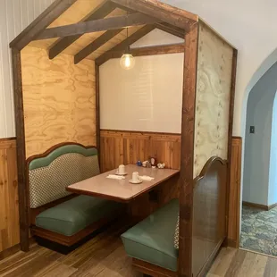 a booth with a table and chairs