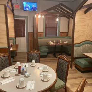 a dining area with tables and chairs