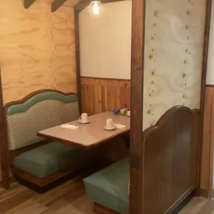 a booth with a table and chairs
