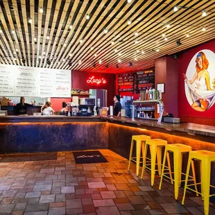 a bar with yellow stools