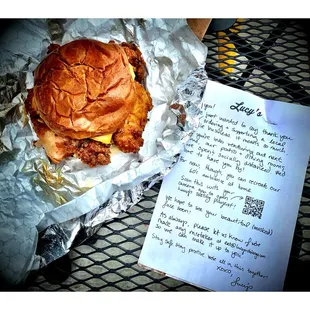 Signature Spicy Fried Chicken! Big Crispy Chunk of fried Chicken(little to greasy),coleslaw,pickles and American cheese. and note from Lucy!