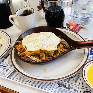 a breakfast of eggs, hash browns and pancakes