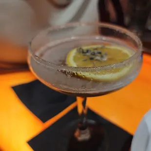 a cocktail with a slice of lemon