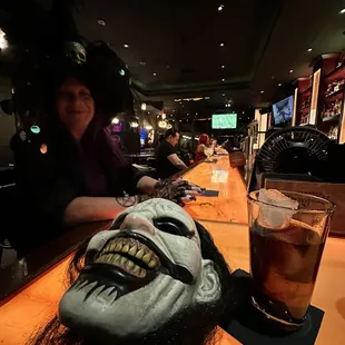 a creepy mask on the bar