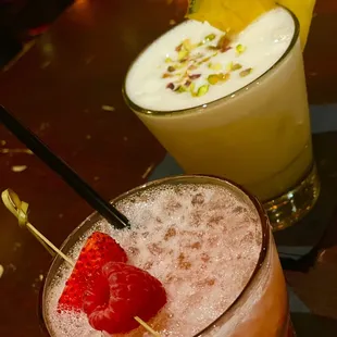 Pinky ( Gordon&apos;s pink gin, lemon juice, simple syrup, raspberries and strawberries) And Apple Blossom Whiskey Sour.