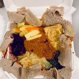 Veggie sampler (Excuse how I ripped open the injera like it was Christmas morning). Lentils x2, greens, cabbage, beets, potatoes and carrots