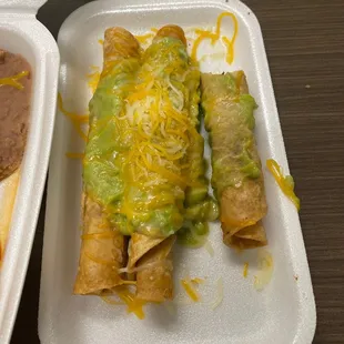 Three rolled tacos. Missing sour cream
