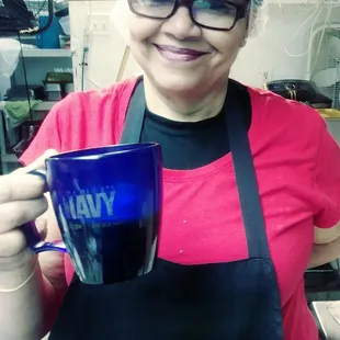 a woman holding a blue mug