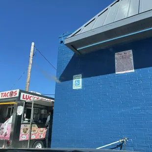 a blue building with a sign on it