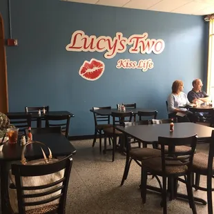 two people sitting at tables in a restaurant