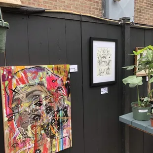 Patio featuring &quot;Dope Art Show&quot; with local artists and plants