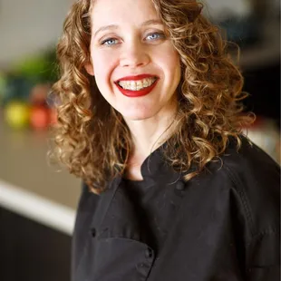 a smiling woman in a black shirt