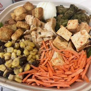 Salad with chicken, carrots, corn, boiled egg, and broccoli