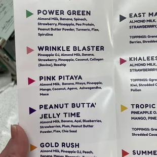 a hand holding a menu