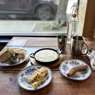 Biscuits w/raspberry preserves, cream cheese grits, scrambled eggs, and country sausage.