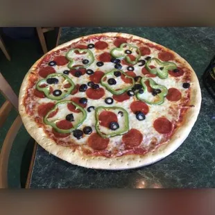 Pepperoni black olives green pepper and onion pizza