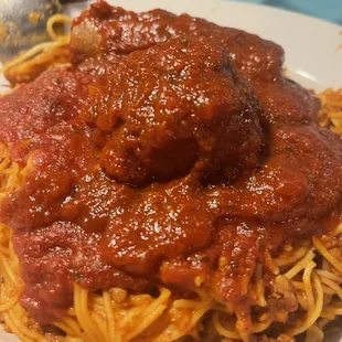 Angel hair spaghetti with meat sauce, a meatball and sausage. A very generous portion!