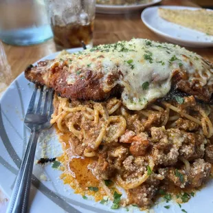 Nice large piece of chicken parmigiana, lightly breaded with spaghetti and meat sauce