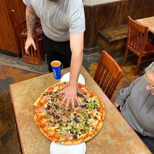 a pizza being served at a restaurant