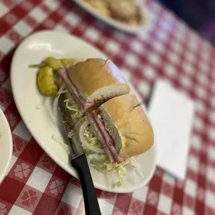 two plates of food on a red and white checkered tablecloth