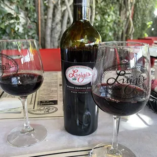 two glasses of wine and a bottle of wine