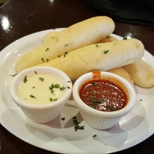 Breadsticks with marinara and Alfredo for dipping.