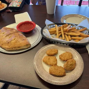 Chicken nuggets, fries, calzone, steak, onions, peppers, cheese