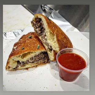 Beef and cheese calzone with marinara sauce