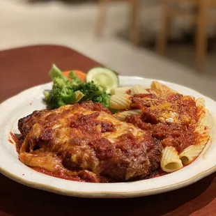 a plate of lasagna and broccoli