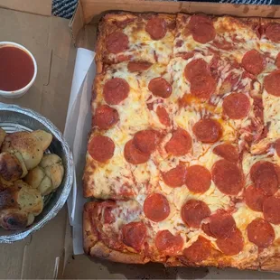 Sicilian pepperoni pizza with garlic knots.