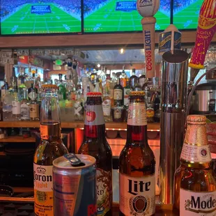 bottles of beer on a bar