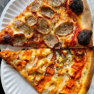 two slices of pizza on a paper plate