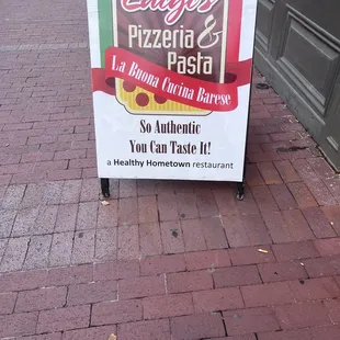 a sign on the sidewalk