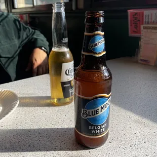 a bottle of pizzeria on a table