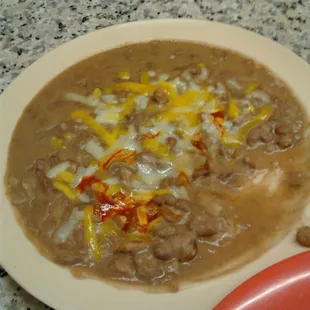 Refried beans with cheese and tapatio