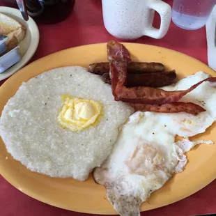 Bacon sausage over easy eggs grits
