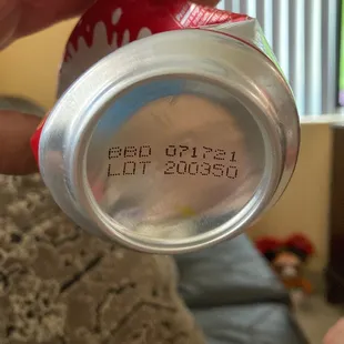 a person holding a can of food