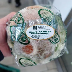 a person holding a bag of doughnuts