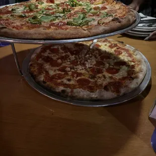 two pizzas on a table