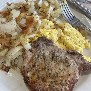 Pork chops scrambled eggs&amp; fried potatoes w/grilled onions