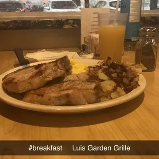 2 pork chops, scrambled eggs, fried potatoes &amp; grits