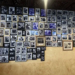 a wall of framed photos