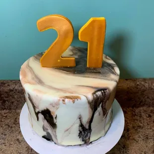 a marbled cake with the number 21 on top