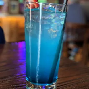 a blue drink with strawberries