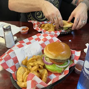 a man eating a burger and fries