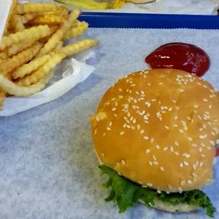 An order of french fries and a cheese burger with lettuce, tomato, and onion.  The fries here are my favorite fries in town.
