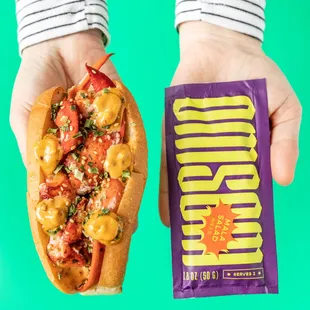 The NEW Spicy Mala Lobster Roll: lobster dolloped with a blend of Omsom Mala sauce + Kewpie mayo, topped with sesame seeds  + chives