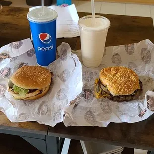 One double cheese burger, one chicken sandwich,  a soda, and a milk shake.