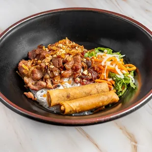 Vermicelli noodle with grilled pork and egg rolls