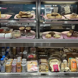 a display case filled with pastries and desserts